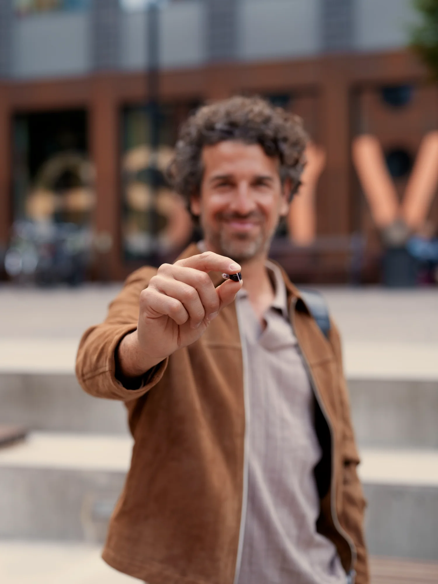 69a7776c133344057b4c9696_oticon_zeal_hero2_stairs_poduct_in_hand_kc_25_2_4660expires_on10_22_2030_edited